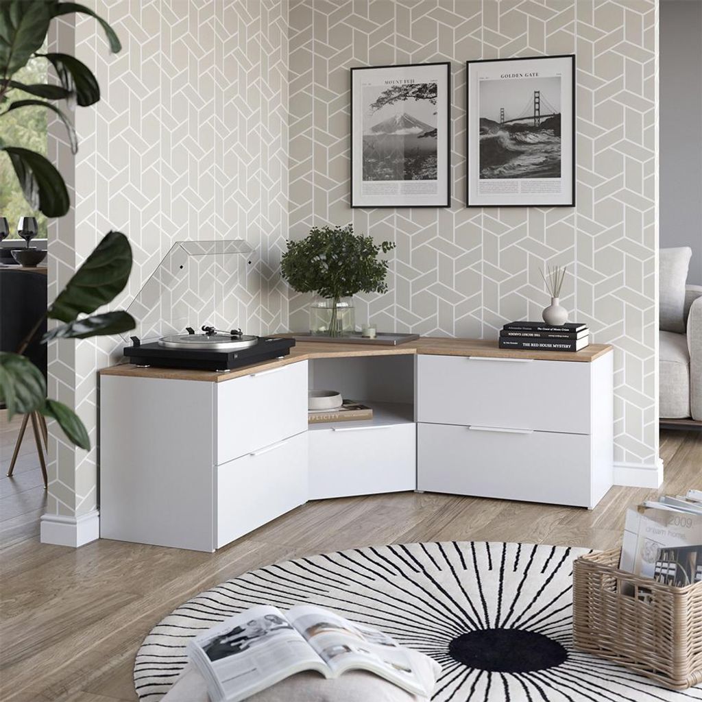 A corner of a living room with a modular media console, turntable, and decorative items.