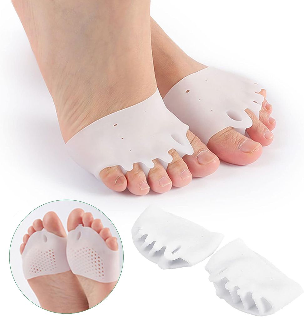A close-up shot of a person's feet wearing white silicone toe separators.