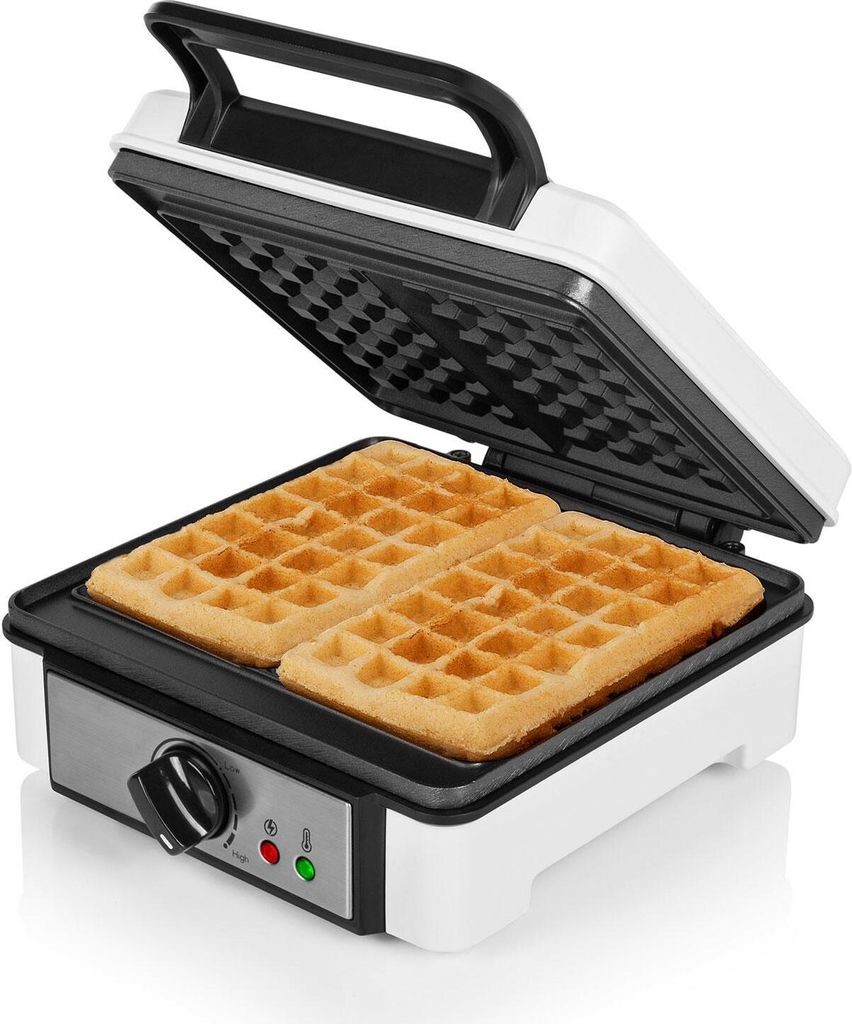 An open waffle maker with two golden-brown waffles inside.