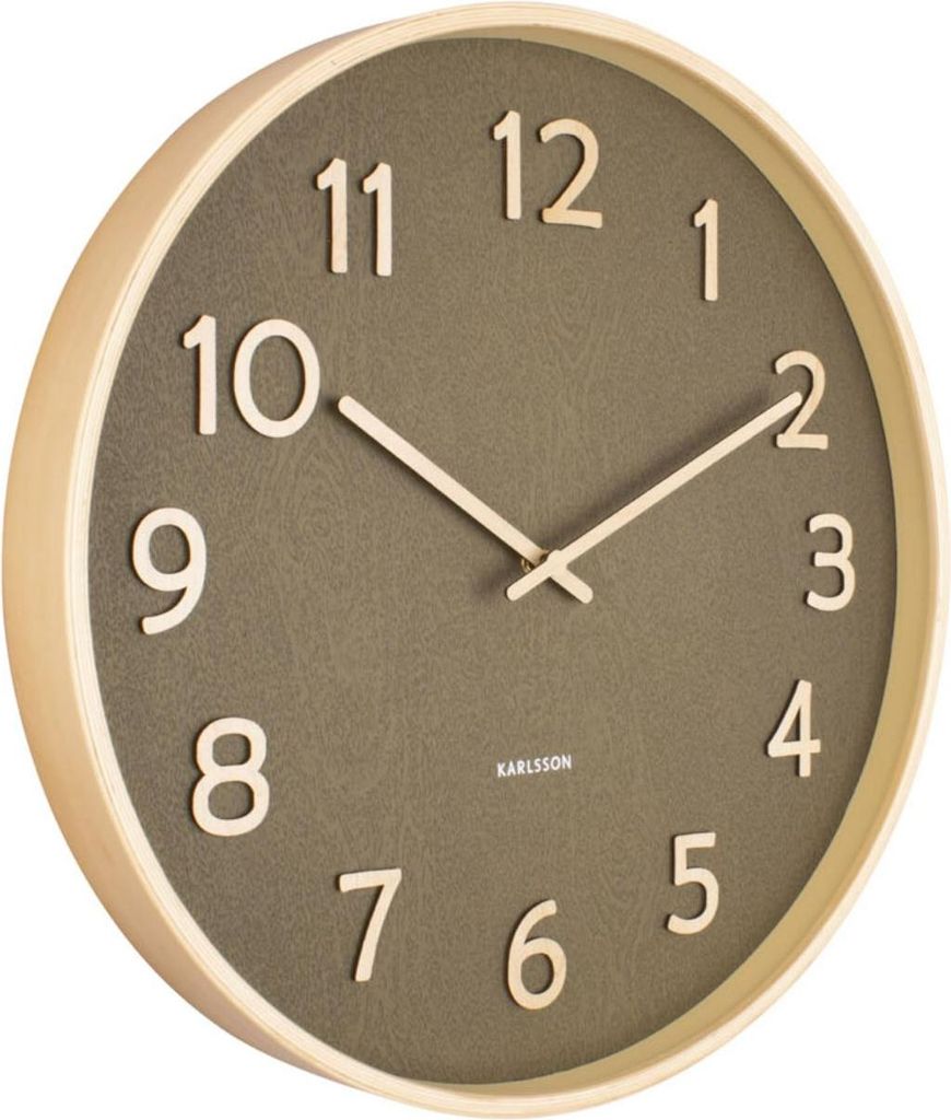 A Karlsson wall clock with a wooden frame and a moss green face.