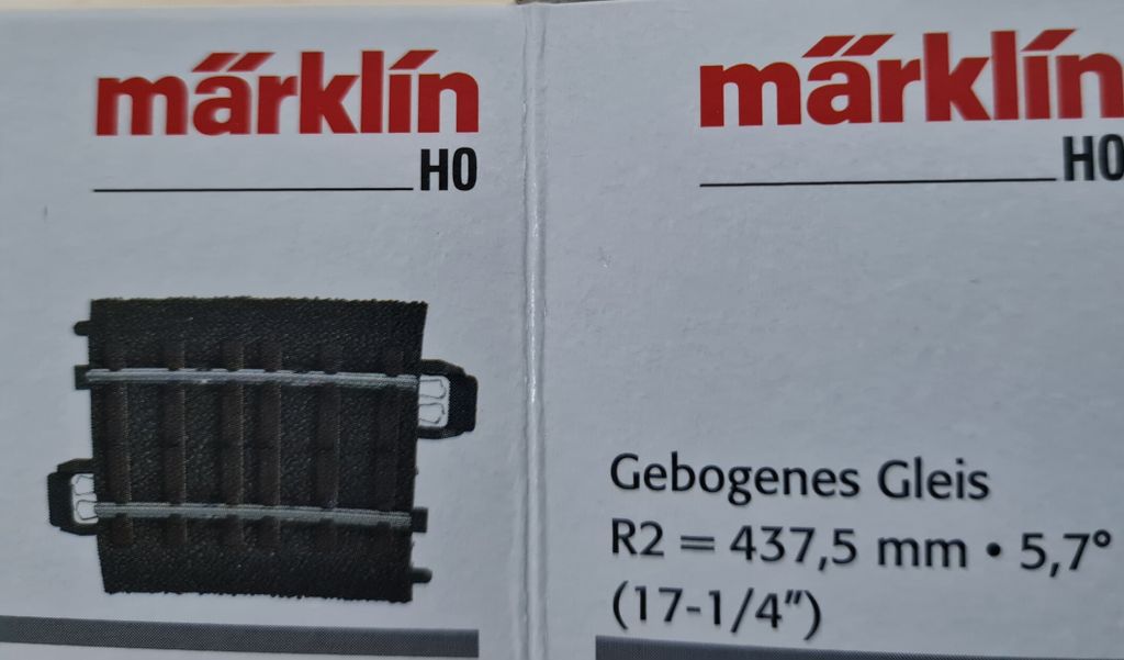 Close-up of two sections of Märklin HO scale model train track packaging.