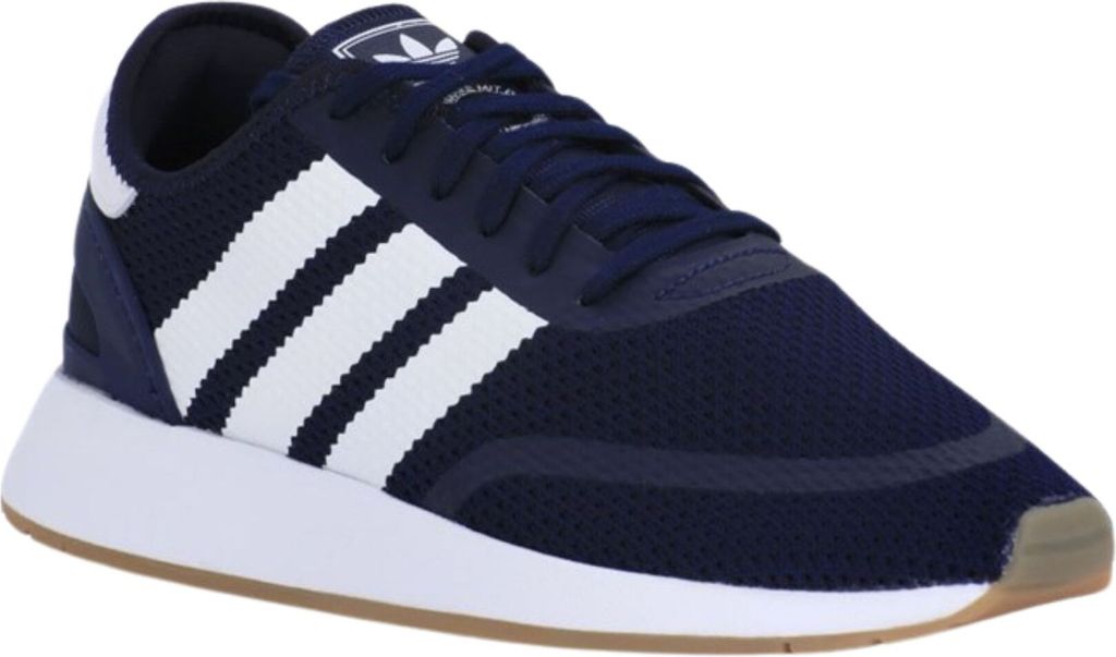 A close-up, side view of a navy blue Adidas sneaker with white stripes.