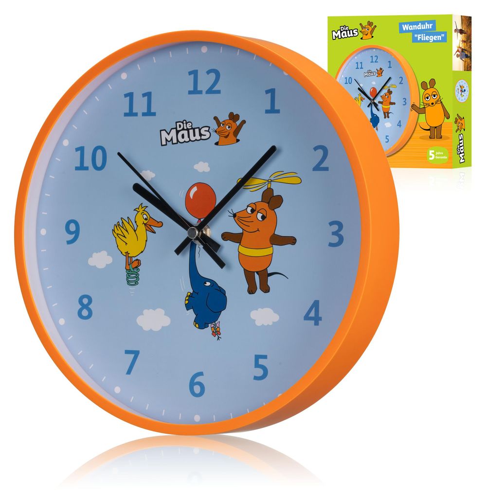A close-up of a children's wall clock with cartoon characters on the face, set against a white background. A product box is visible in the upper right corner.