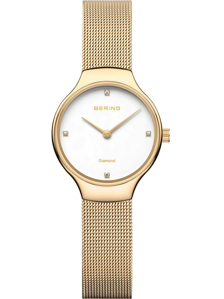 A close-up studio shot of a gold Bering watch with a white face and diamond markers.