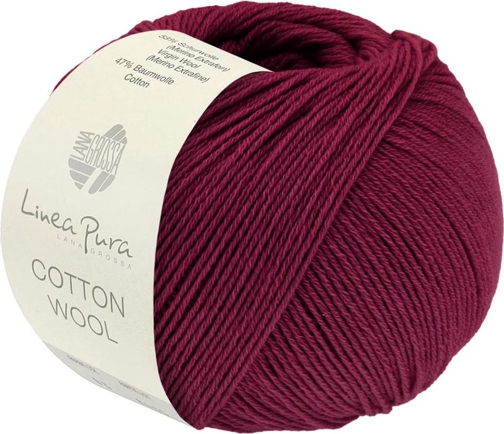 A ball of burgundy yarn with a label.