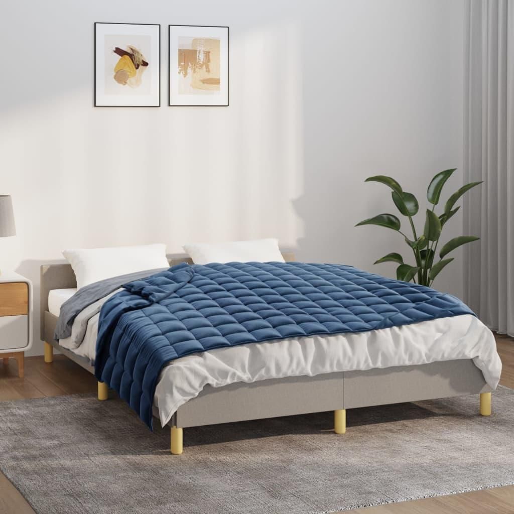 A bedroom scene with a bed, bedding, and artwork on the wall.