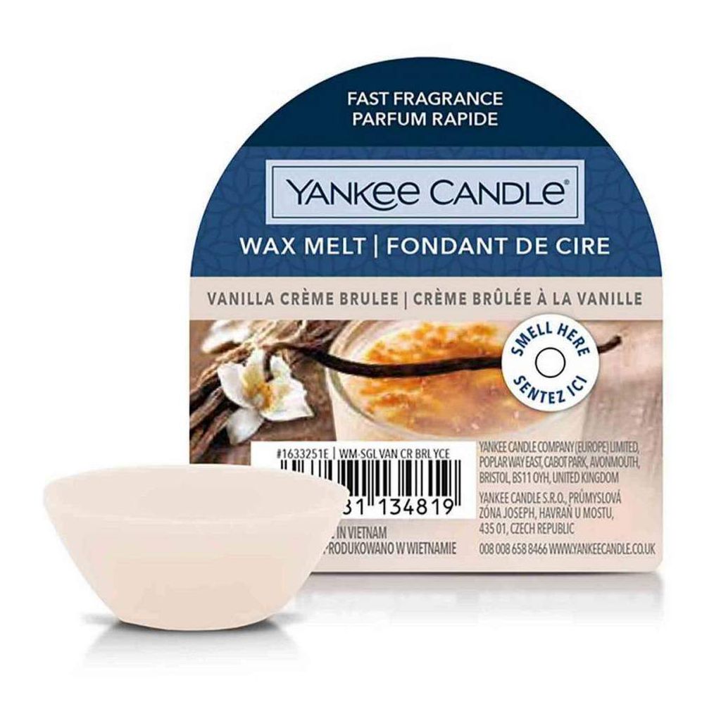 A Yankee Candle wax melt in Vanilla Crème Brûlée scent, with packaging in the background.