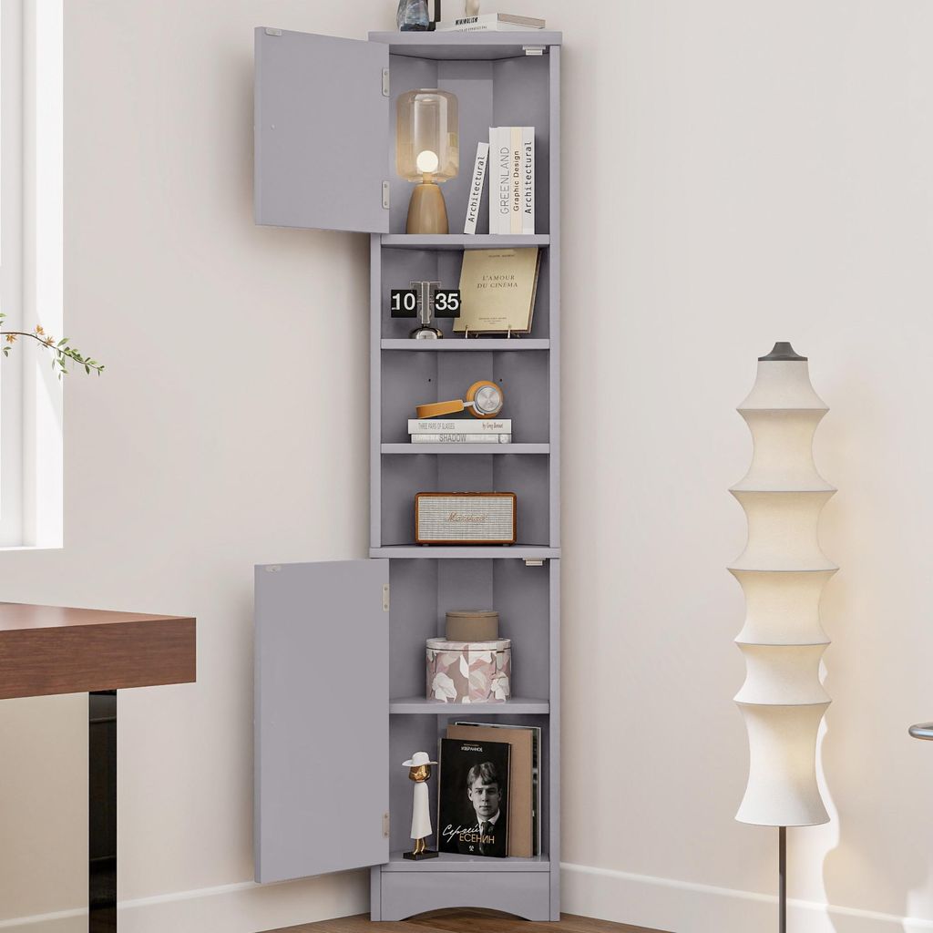 A gray corner cabinet with open shelves and two doors, displaying various decorative items and books.