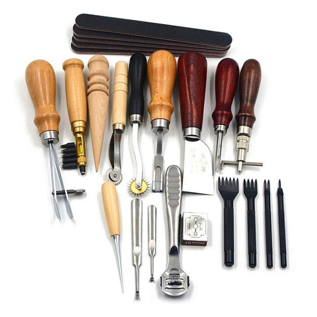 A collection of leather crafting tools laid out on a white background.
