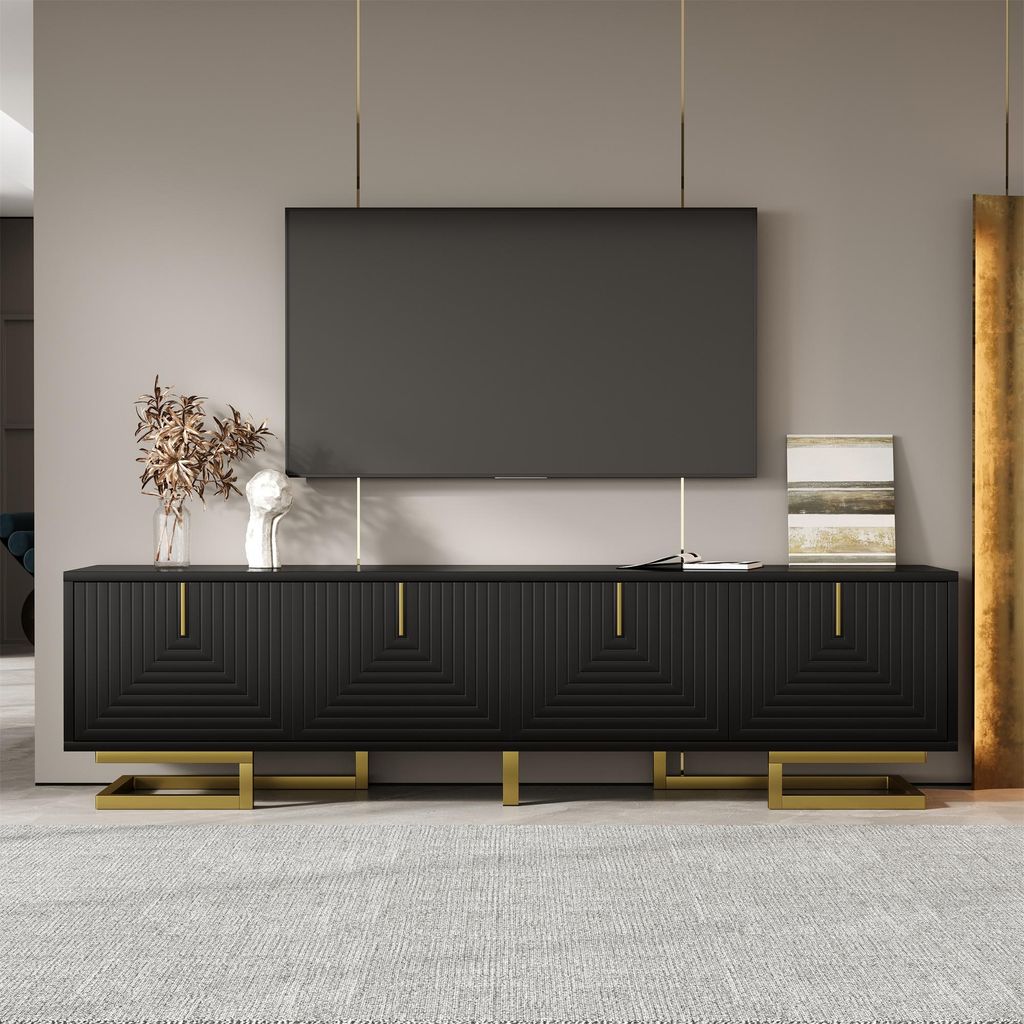A modern living room with a black TV stand and a large flat-screen TV mounted above it.