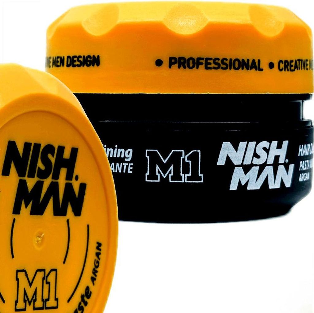 Two containers of Nishman M1 hair product are shown against a white background. One container is in the foreground and is yellow, while the other is in the background and is black with a yellow lid.