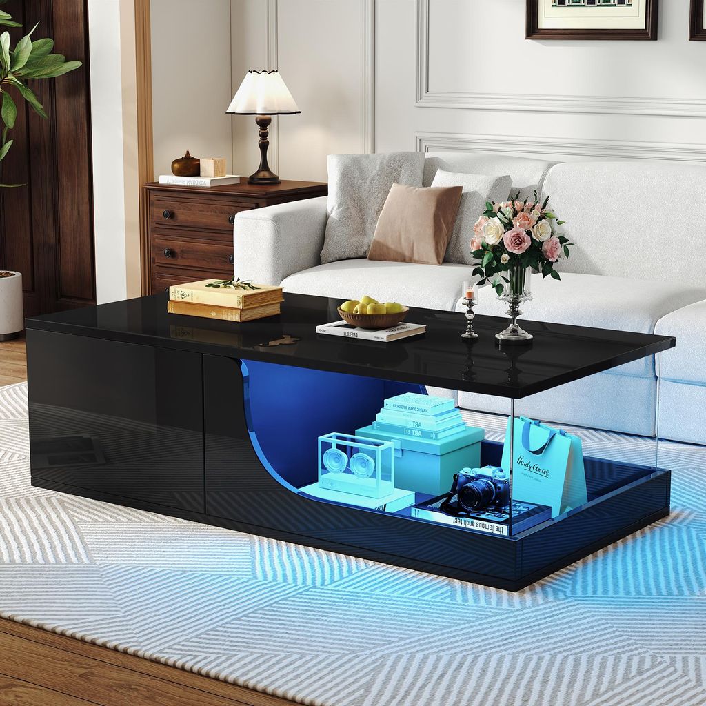 A modern living room scene featuring a black high-gloss coffee table with LED lighting.