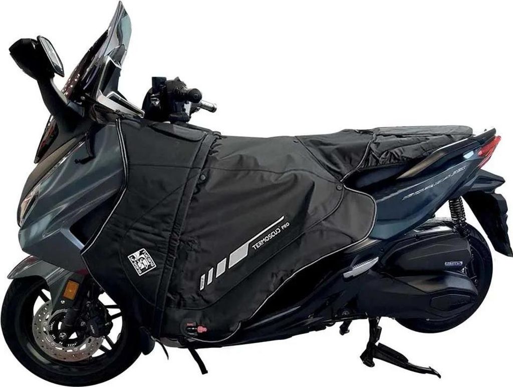 A scooter with a black leg cover attached.
