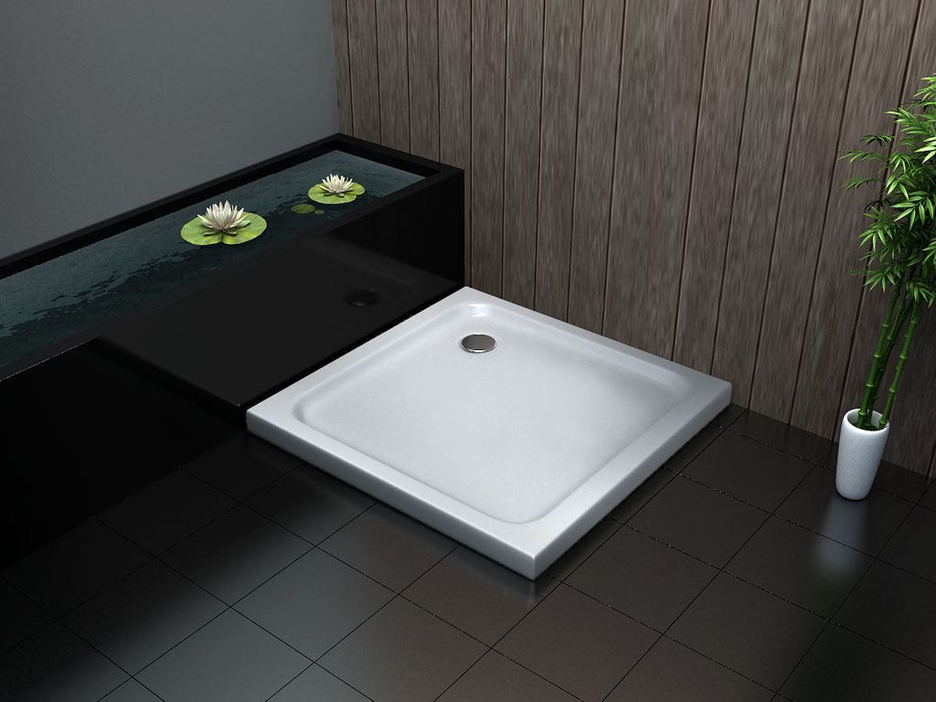 A modern bathroom with a shower tray, a water feature with lily pads, and bamboo plants.