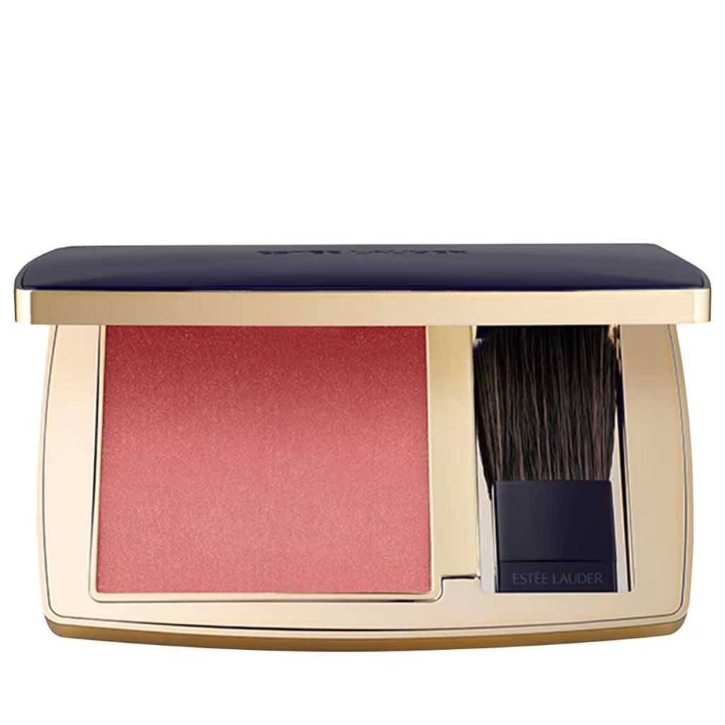 A close-up studio shot of an open Estée Lauder blush compact with a brush.