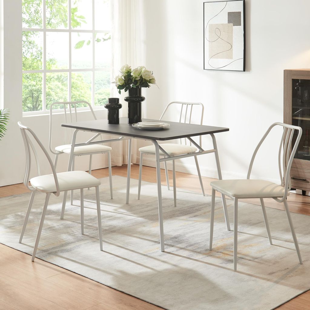 A dining set with a rectangular table and four chairs in a well-lit room.