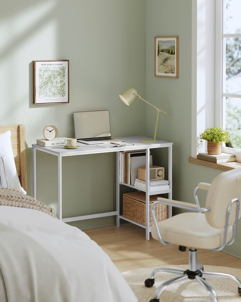 A corner of a bedroom with a desk, chair, and bed.
