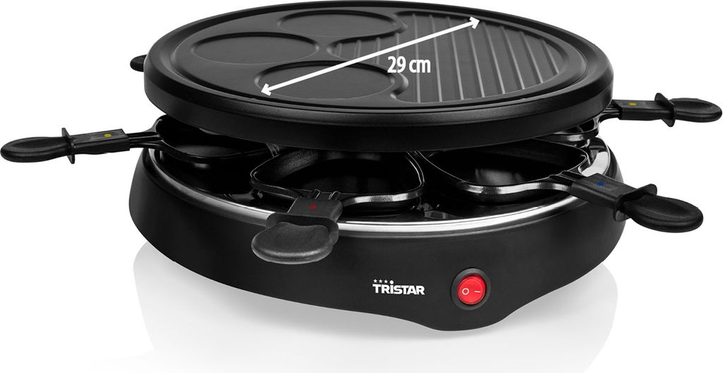 A black electric raclette grill with a griddle top and multiple small pans underneath, shown from a slightly elevated front-left angle on a white background.
