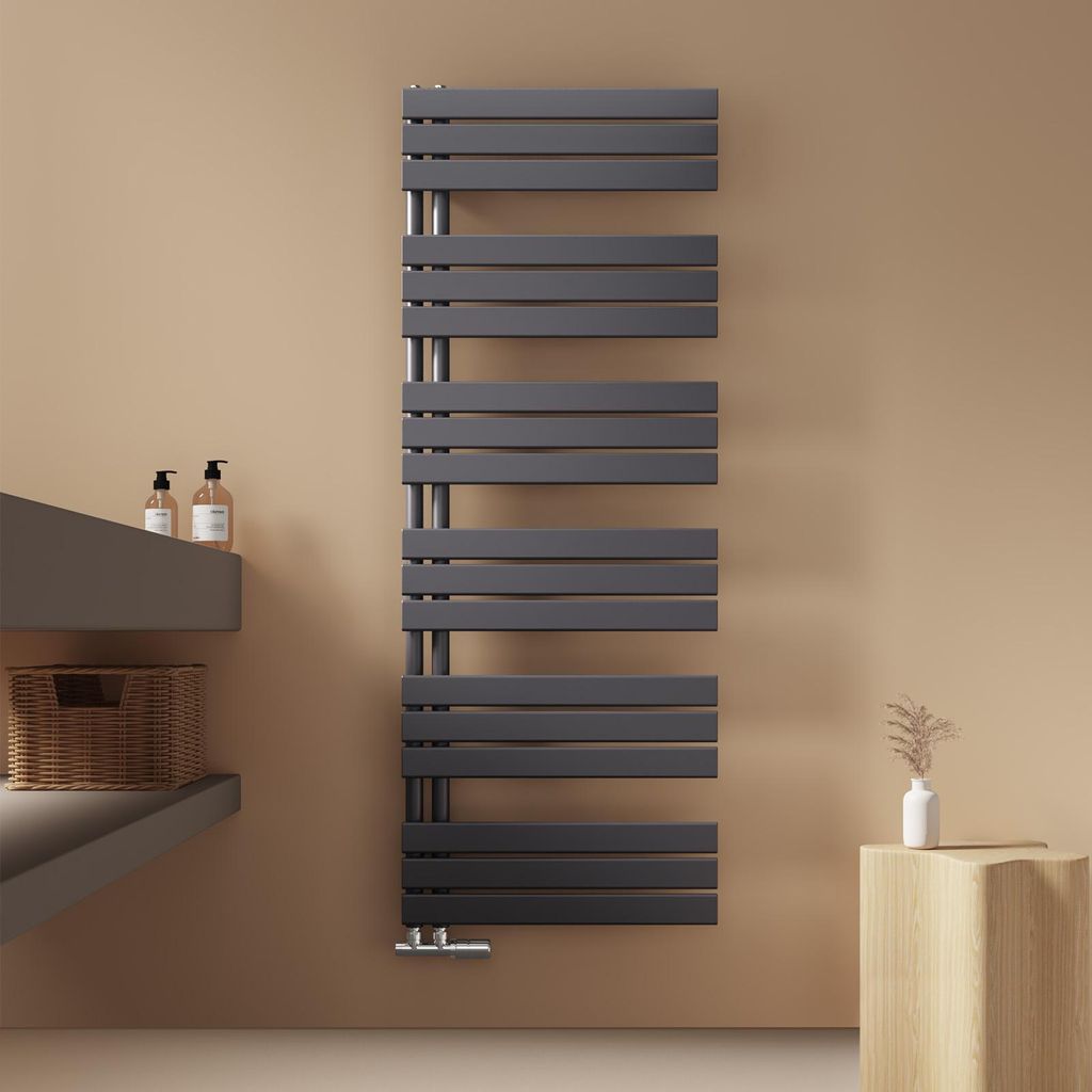 A modern bathroom setting with a grey towel radiator, a grey vanity unit with soap dispensers and a basket, and a small wooden stool with a vase.