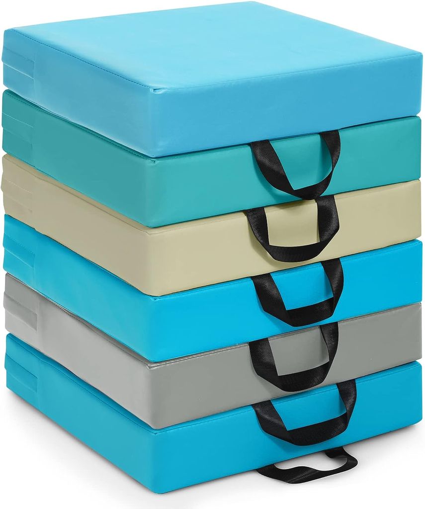 A stack of six square floor cushions in various colors, each with a black handle.