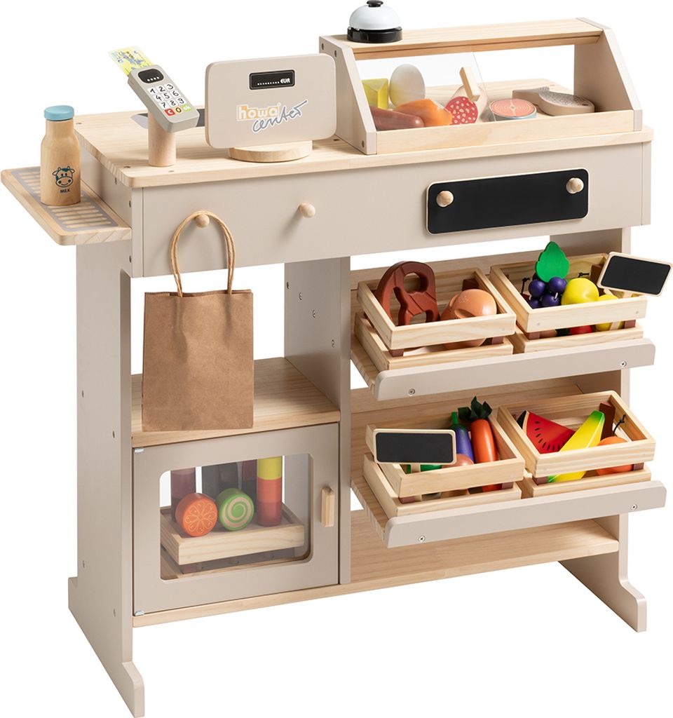 A wooden toy shop counter with various toy food items displayed in crates and on shelves.