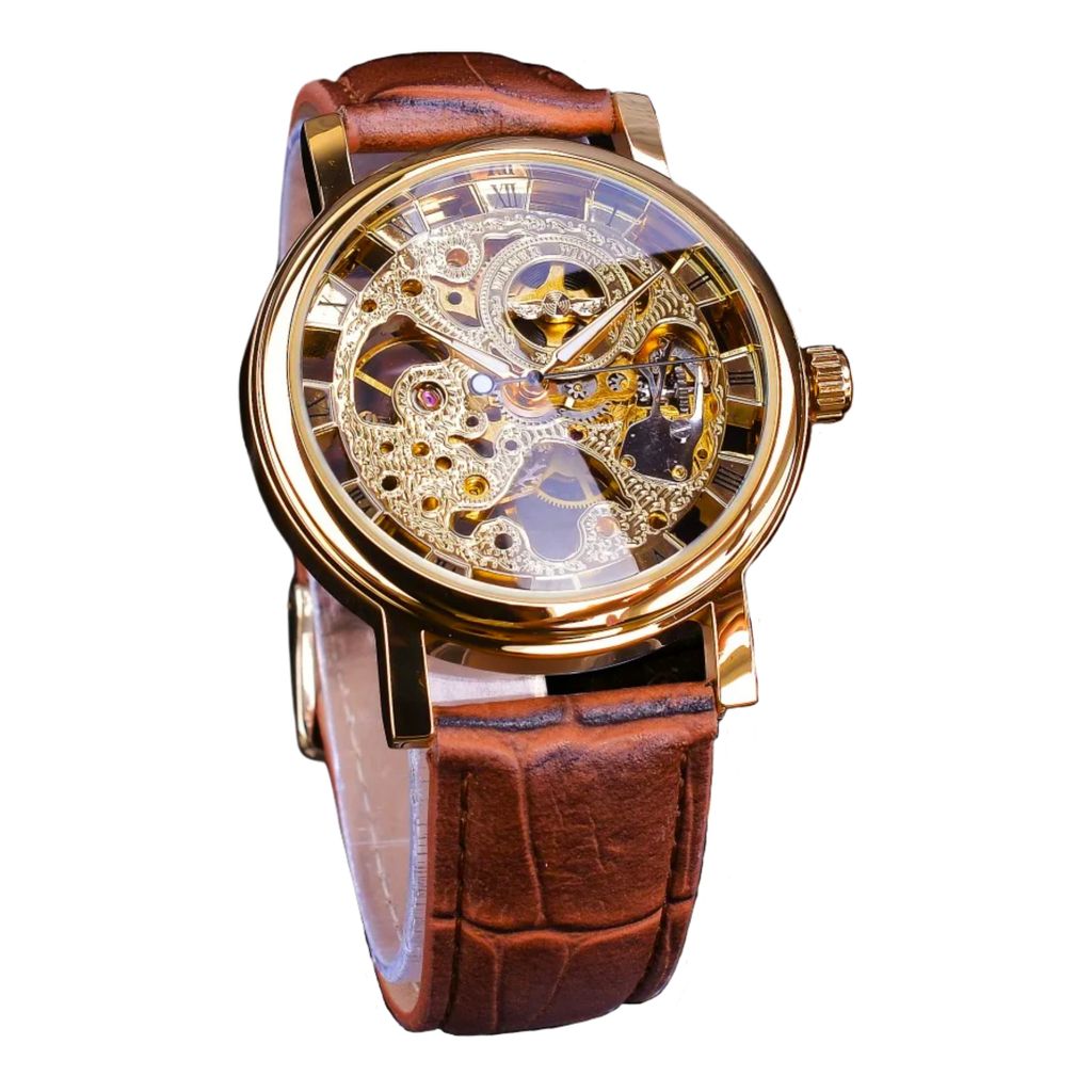 A close-up studio shot of a men's automatic skeleton watch with a gold-tone case and a brown leather strap.