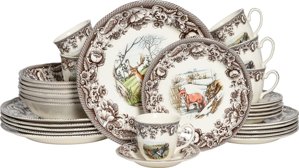 A collection of dinnerware, including plates, bowls, and cups, with a nature-themed design.