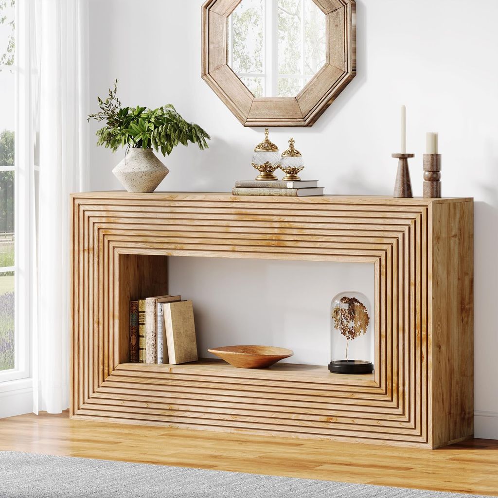 A light brown wooden console table with a ribbed design in a living room setting.