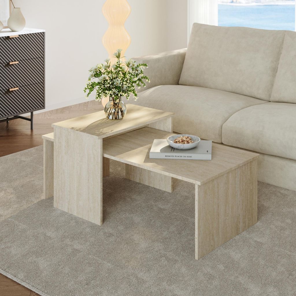 A living room scene with a sofa, a cabinet, and a nesting coffee table set.