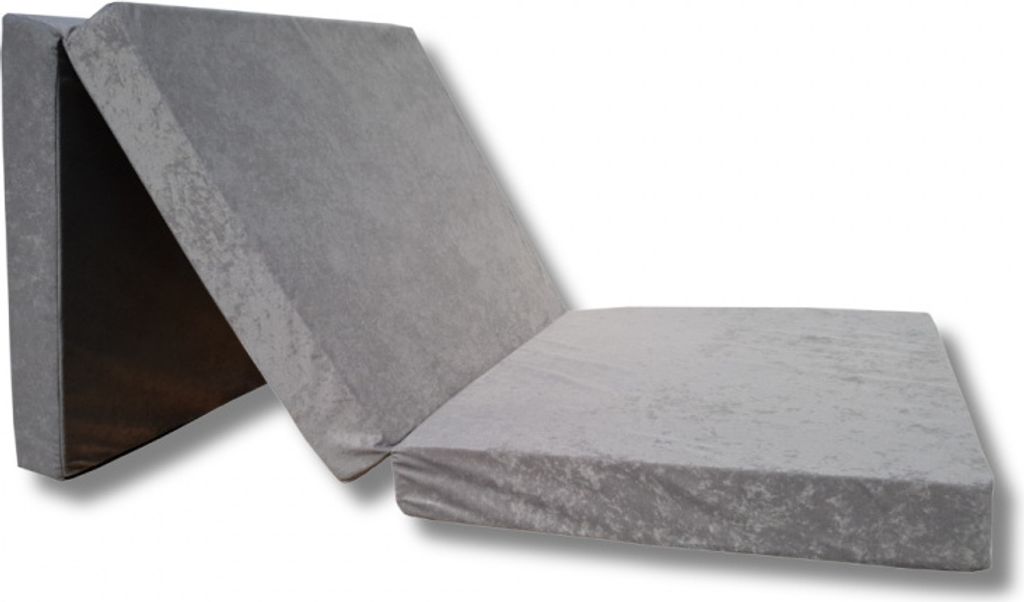 A folded mattress laying on a white background.