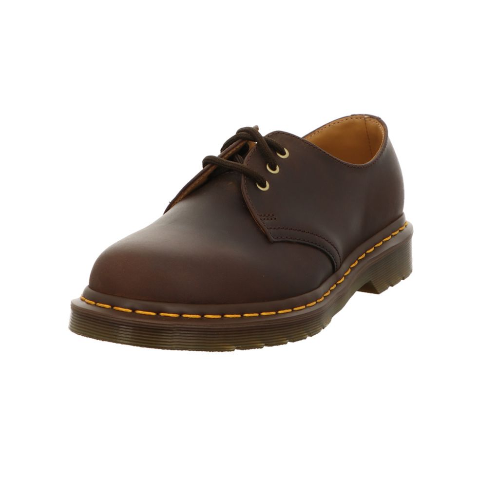 A single brown Dr. Martens shoe is shown against a white background.