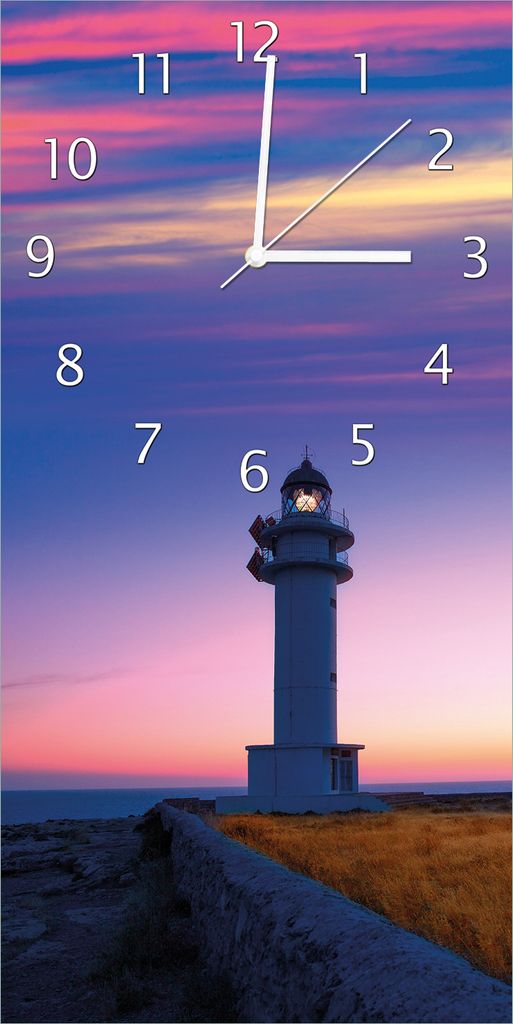 Wallario Design Wanduhr bedruckt, Größe 30 x 60 cm, Motiv: Leuchtturm am Abend auf den Balearen Malerischer Himmel