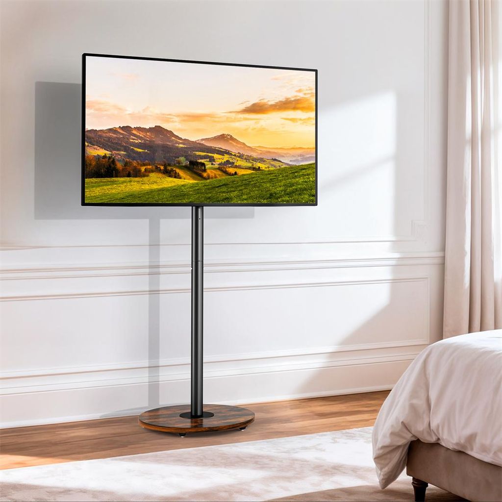 A TV stand with a TV displaying a landscape image, placed in a bedroom setting.