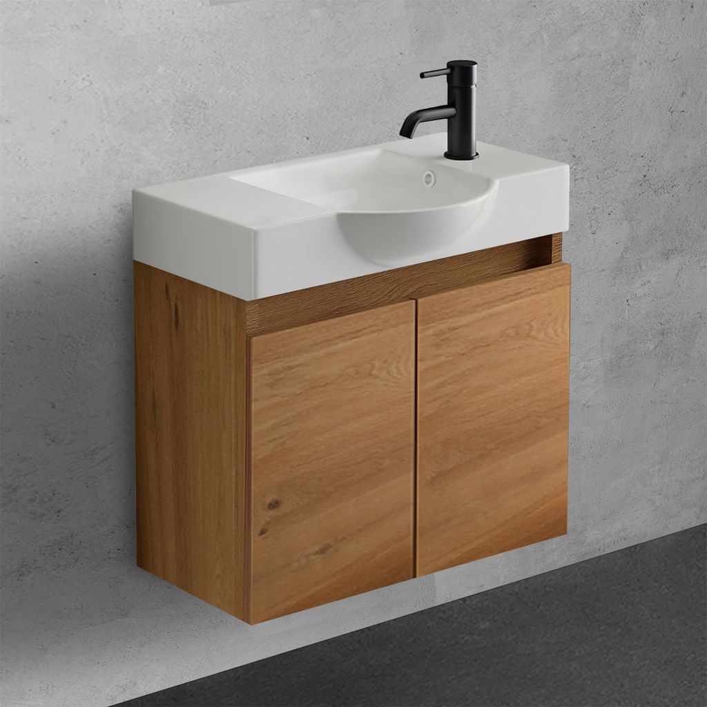A modern bathroom vanity with a white sink and a wooden cabinet against a concrete wall.