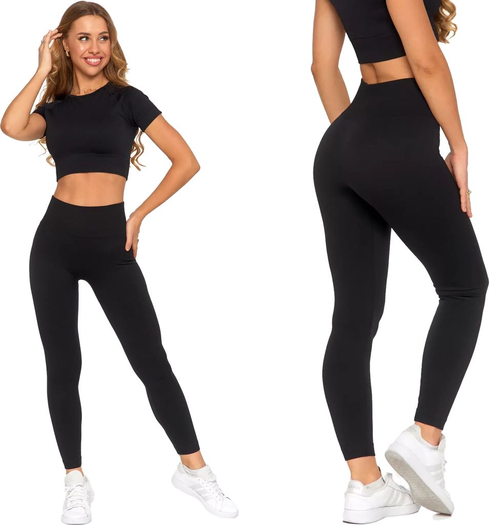 A woman modeling black leggings and a crop top.