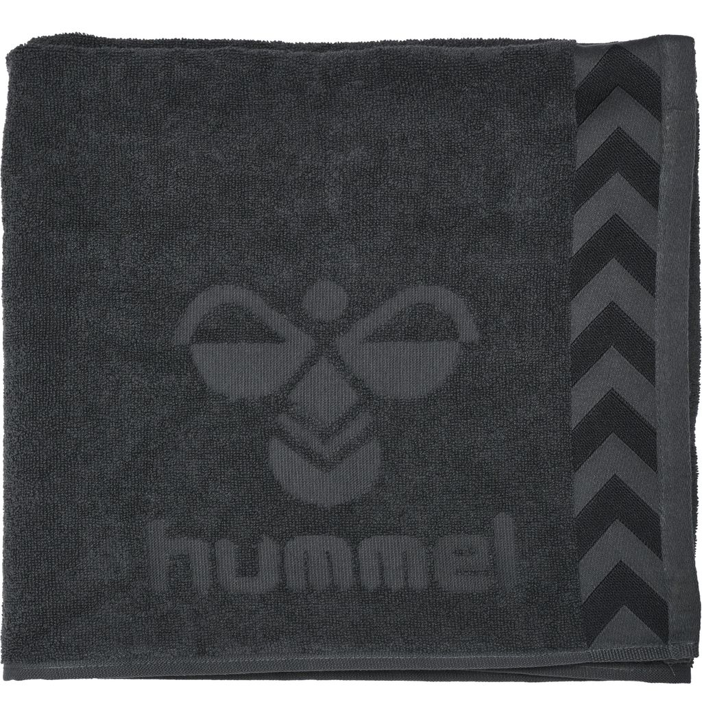 A dark gray towel with the Hummel logo and brand name embossed on it.