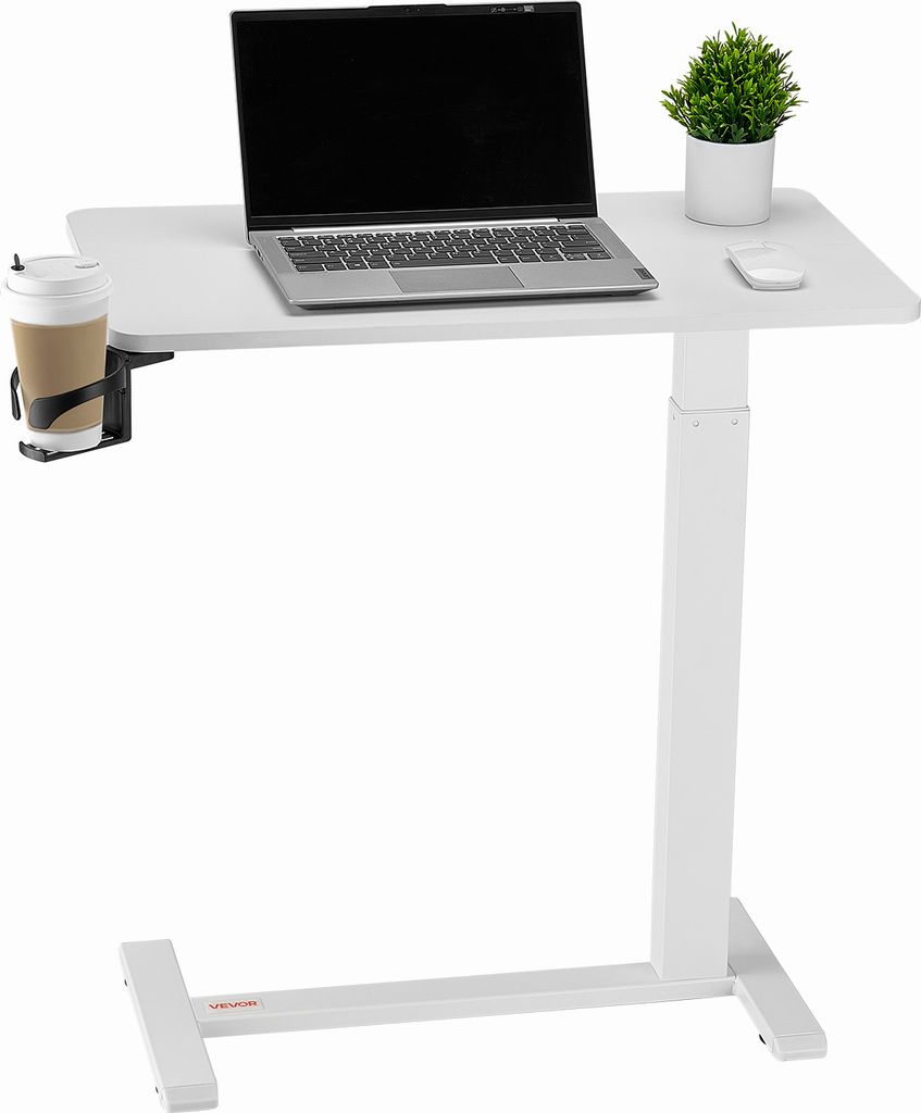 A white adjustable height desk with a laptop, a plant, and a cup holder with a cup.