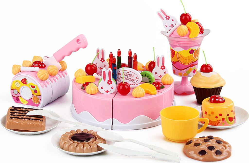 A collection of toy birthday cake and dessert items, including a pink cake, cupcakes, a milkshake, cookies, and a cutting toy.