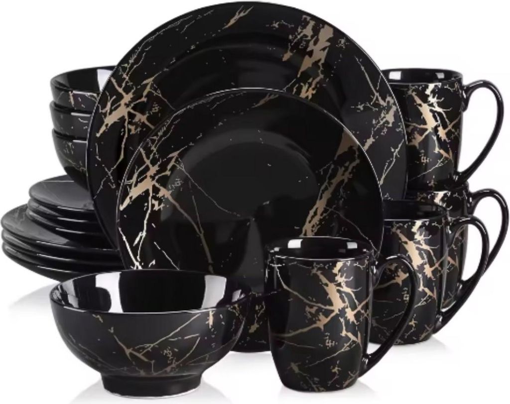 A set of black and gold marble-patterned dinnerware, including plates, bowls, and mugs, is neatly arranged against a white background.