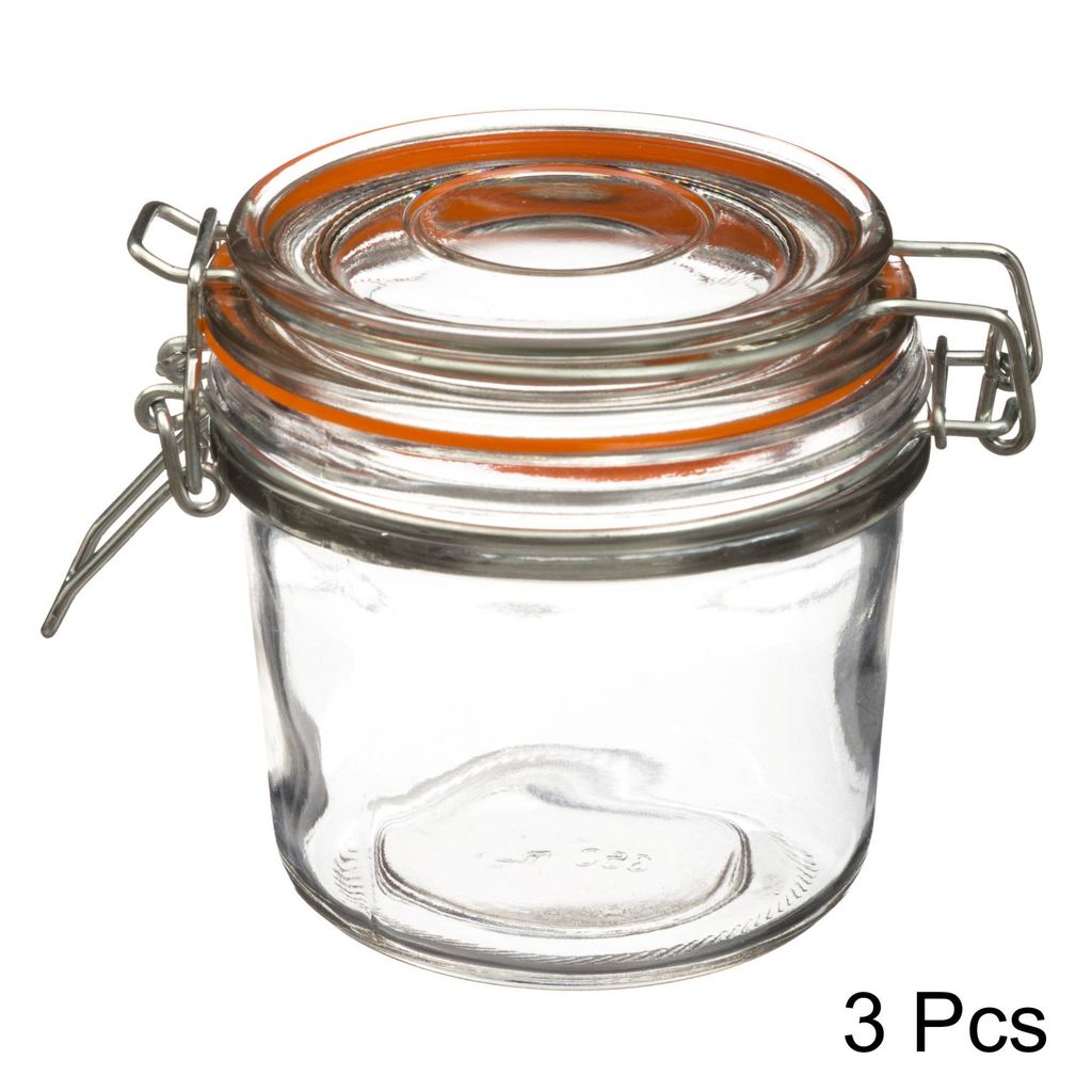 A clear studio shot of a glass jar with a clamp lid.