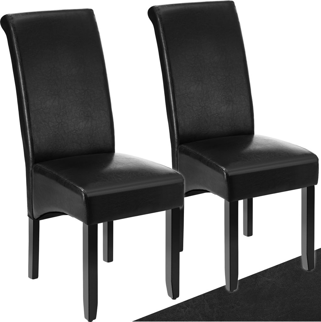 Two black dining chairs are shown against a white background.