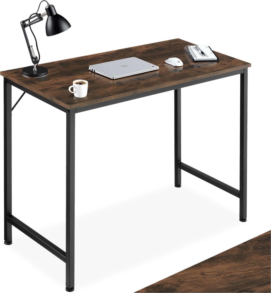 A desk with a laptop, mouse, notebook, and coffee cup on it.