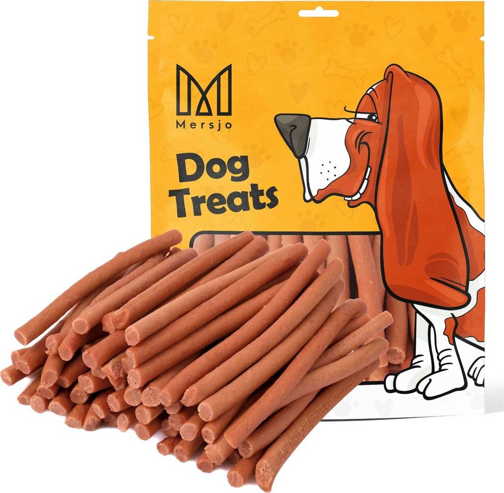 A bag of dog treats with a pile of treats in front of it.