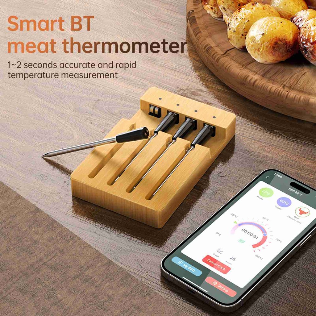 A smart BT meat thermometer set with probes in a wooden holder and a smartphone displaying the app interface on a wooden table surface.