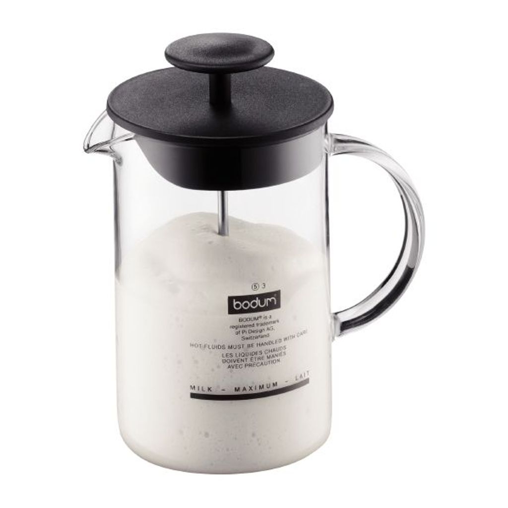 A Bodum milk frother filled with frothed milk.