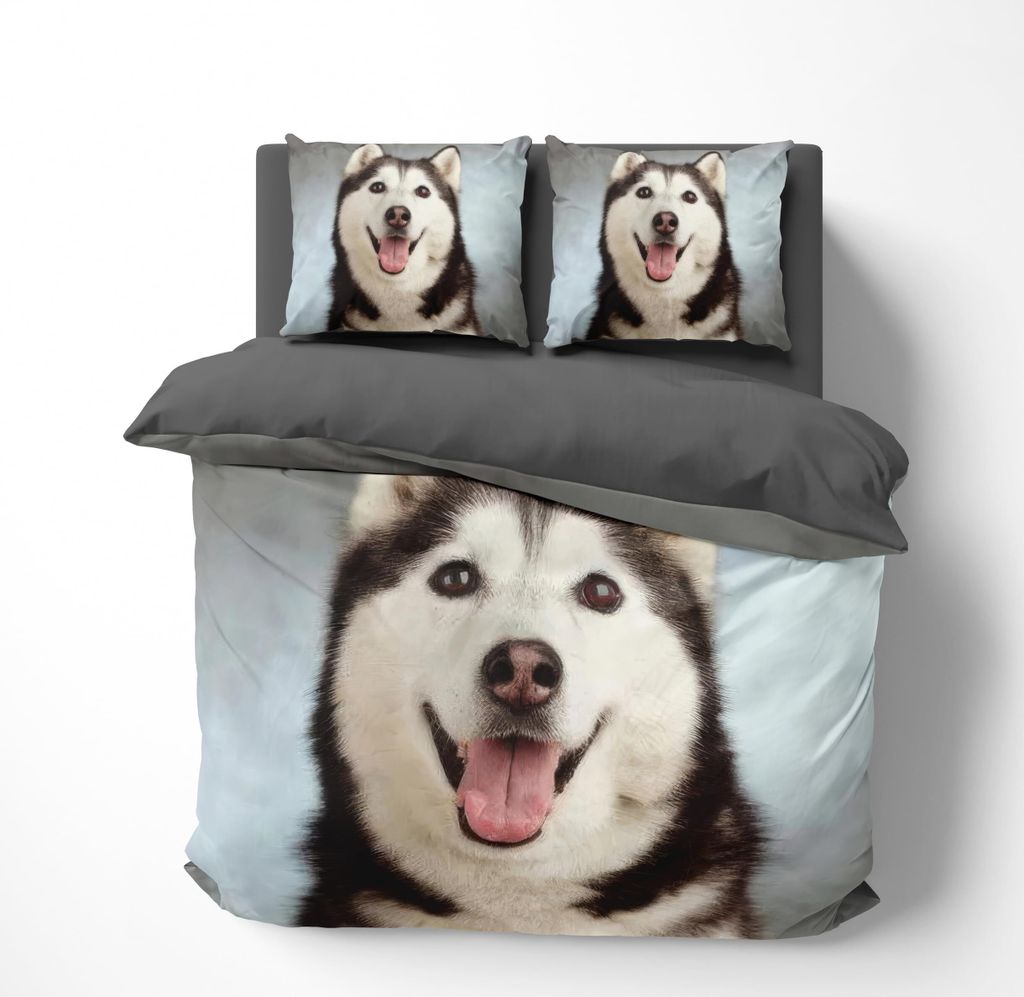 A duvet cover and pillowcase set featuring a husky dog print, laid out on a bed.