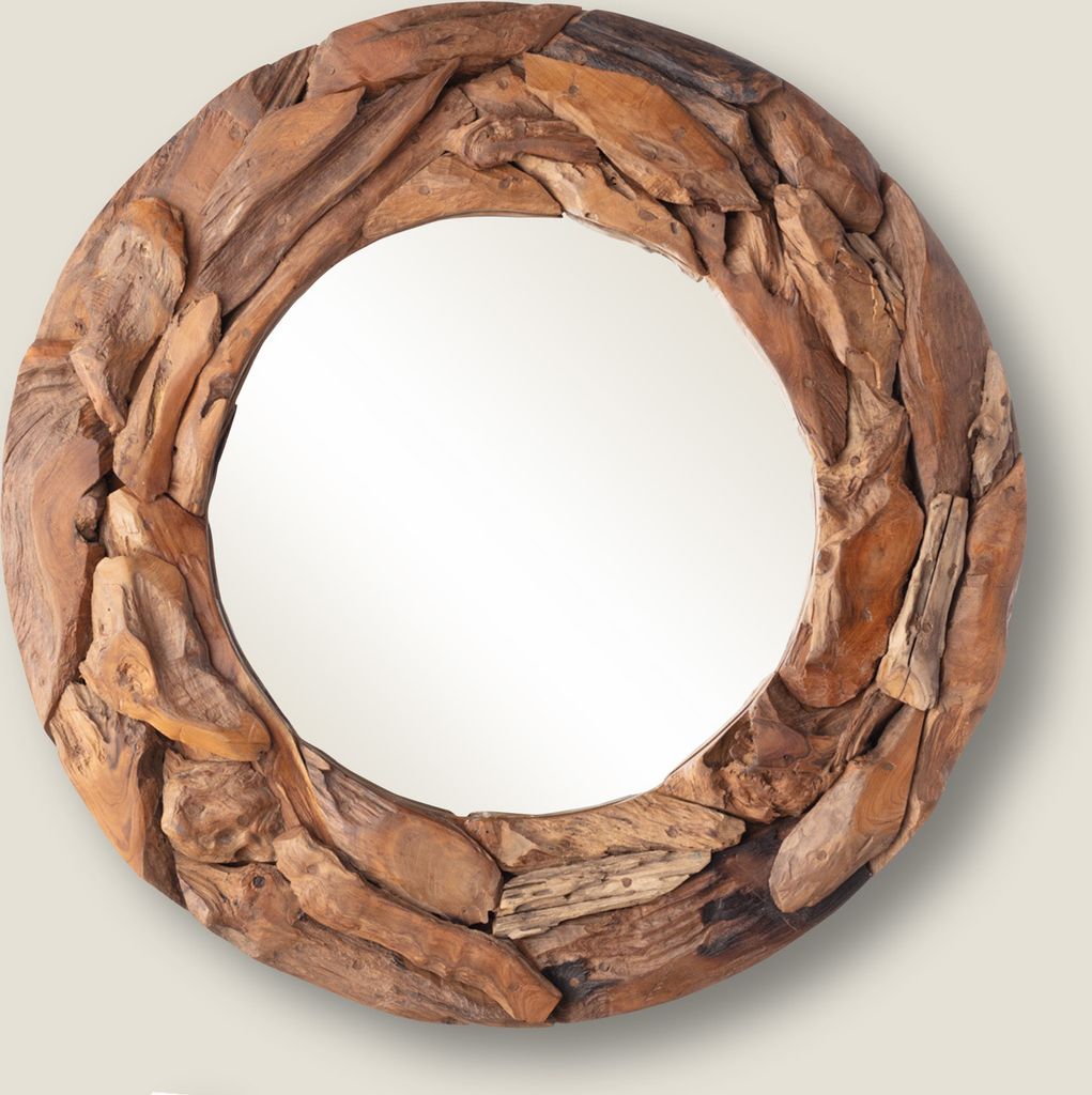 A round mirror with a frame made of driftwood.