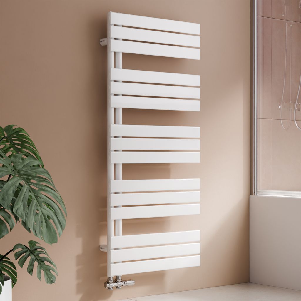 A white designer radiator in a bathroom setting, next to a large potted plant and a shower enclosure.