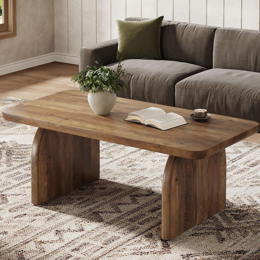 A living room scene with a coffee table, sofa, and rug.