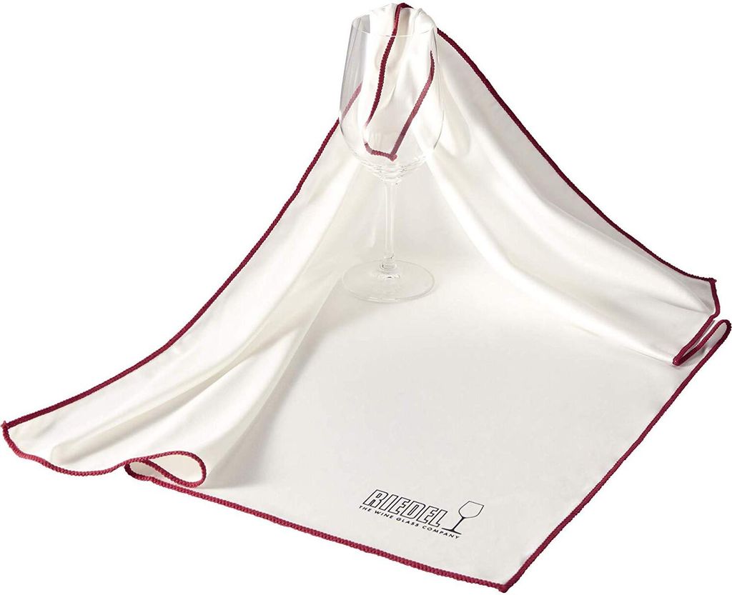 A white microfiber cloth with a red border is draped over a clear wine glass.